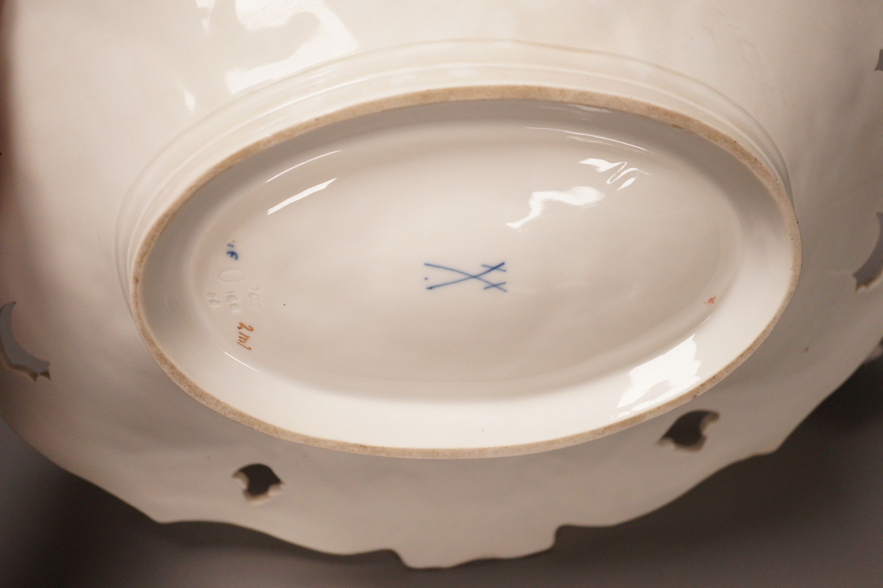 An early 20th century Meissen two handled white and gilt floral oval dish, 32cm